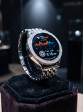 Round silver-tone Eastern Promise watch concept with stone-set bezel, sculptural links and illustrative Fajr and heart-rate display. Precious materials and functions are unverified.