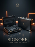 Signore Carbon Travel Collection campaign with an open black briefcase containing a folded garment and accessories beside a closed carbon-pattern briefcase.